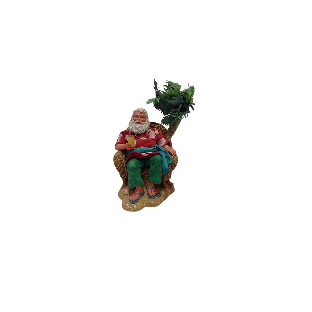 Vintage hawaiian kurt adler fabriche santa under palm tree in chair under tree.